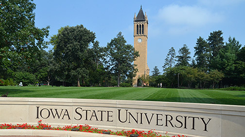 Photo of Iowa State University sign with Camponile among trees
